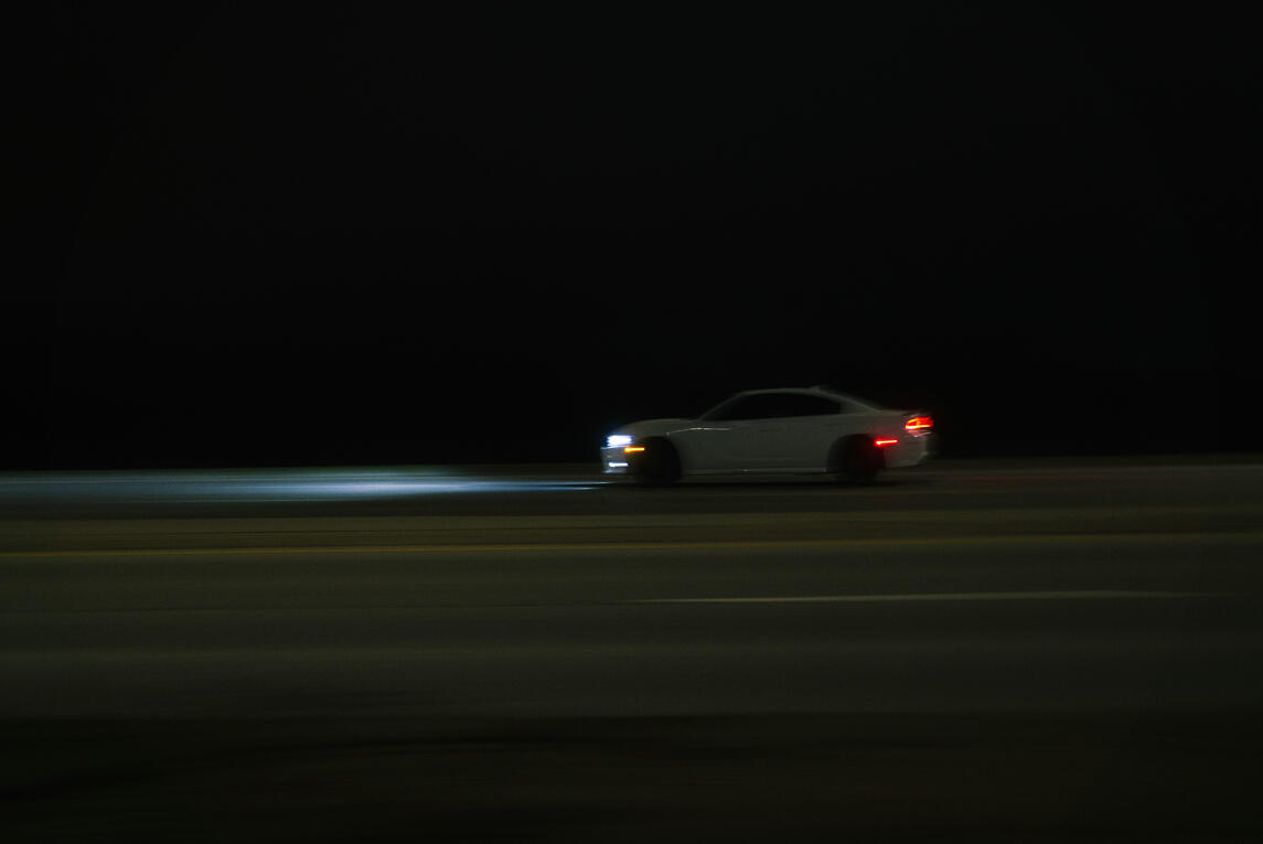 A long exposure shot of a Dodge Charger on a highway