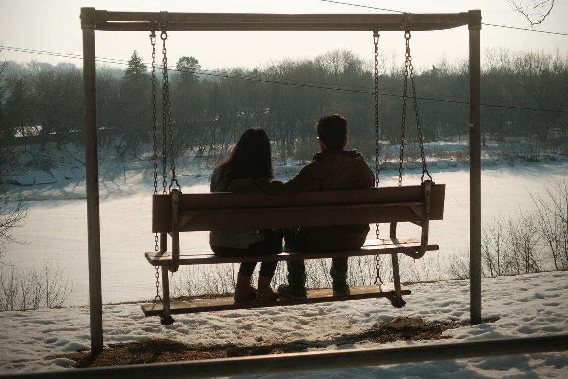 A couple shares a moment of peace at the swings